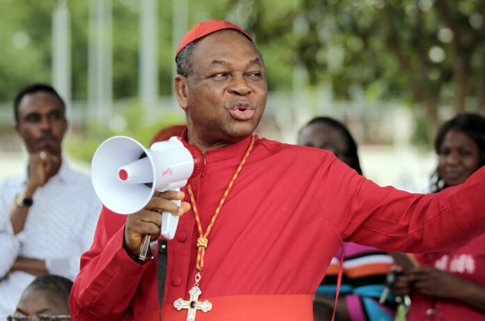 Catholic Archbishop of Abuja John Onaiyekan addresses Bring Back Our Girls (BBOG) campaigners during a protest procession marking the 500th day since the abduction of girls in Chibok, along a road in Abuja