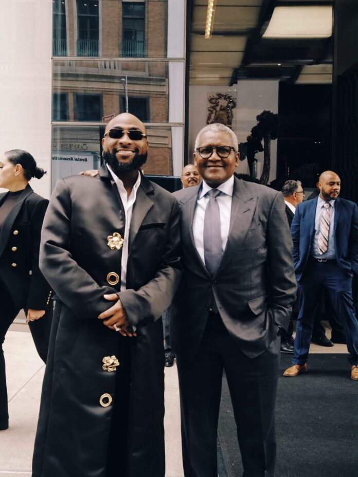 Davido and Dangote under Dangote Refinery billboard in Times Square